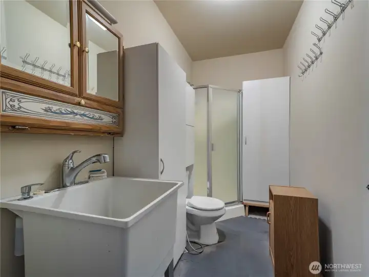 3/4 bathroom off the garage...perfect for cleaning up after working on the yard, or maybe update for a dog bathing/grooming station...