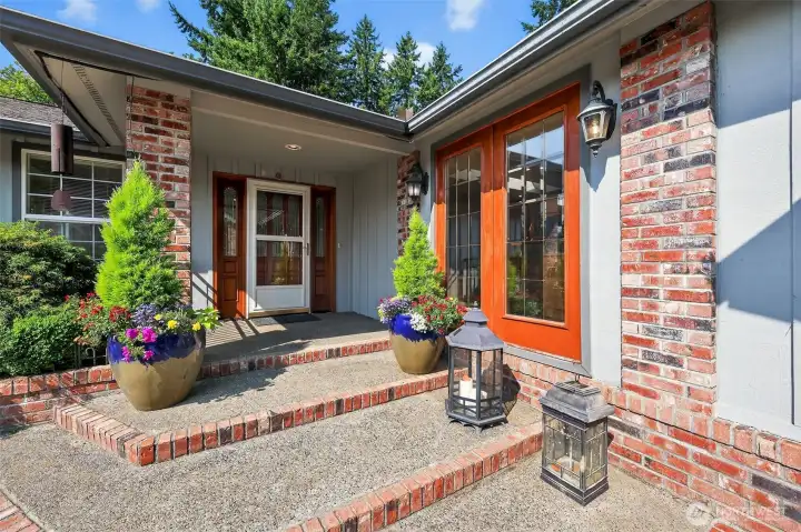 A lush, landscaped front entry courtyard provides a serene welcome to the home.”