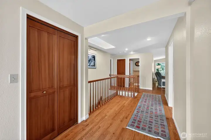 The entry hallway, leading from the front sitting area, is accented by beautiful hardwood flooring for a timeless appeal.
