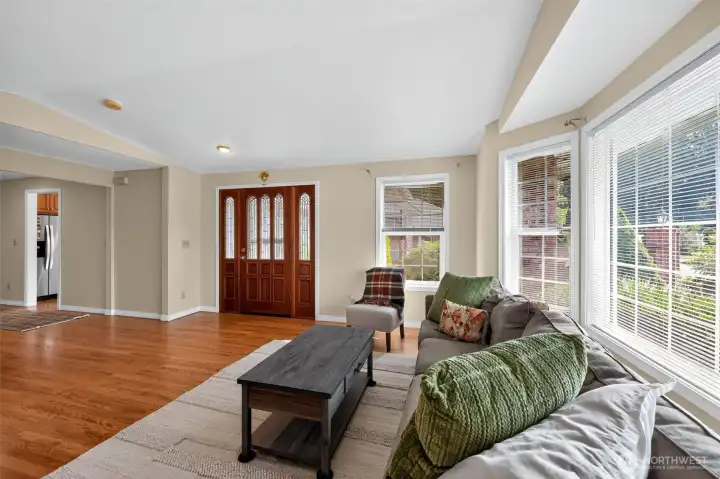 Designed for both comfort and style, the family room boasts a brick fireplace, sweeping windows, and expansive seating for cherished family time.