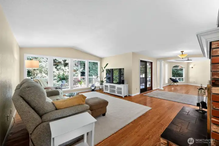 Designed for both comfort and style, the family room boasts a brick fireplace, sweeping windows, and expansive seating for cherished family time.