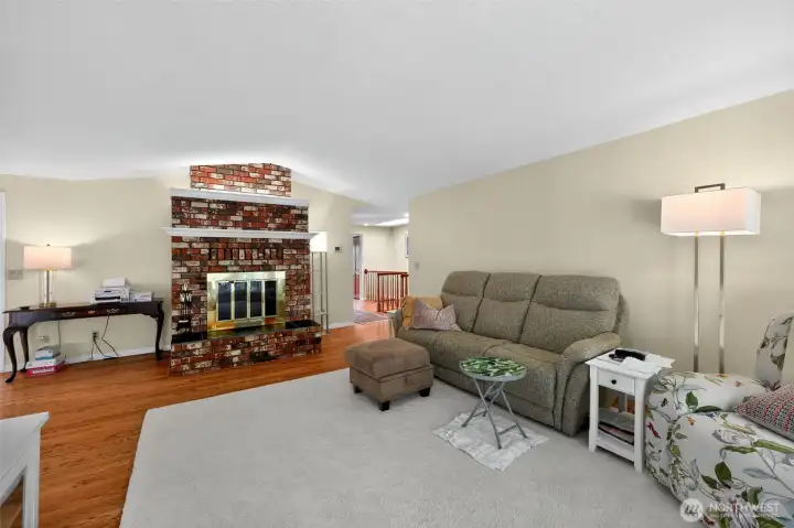 Designed for both comfort and style, the family room boasts a brick fireplace, sweeping windows, and expansive seating for cherished family time.