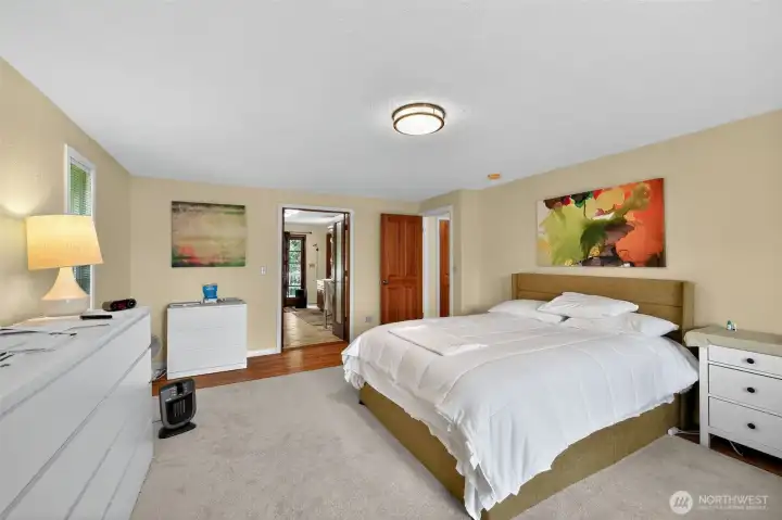 Retreat to the spacious master suite, where large windows capture the beauty of the morning light.