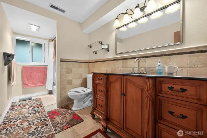 The master suite is complemented by a spacious spa-inspired bathroom featuring rich wood cabinetry, granite countertops, an oversized linen closet, a jetted soaking tub, and a separate shower.”