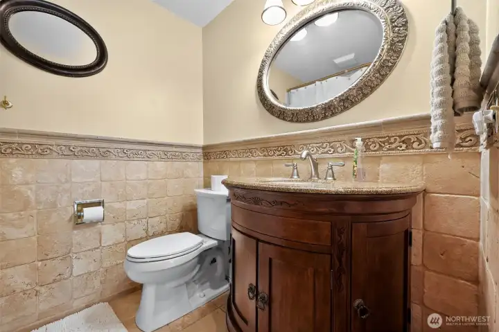 The master suite is complemented by a spacious spa-inspired bathroom featuring rich wood cabinetry, granite countertops, an oversized linen closet, a jetted soaking tub, and a separate shower.”