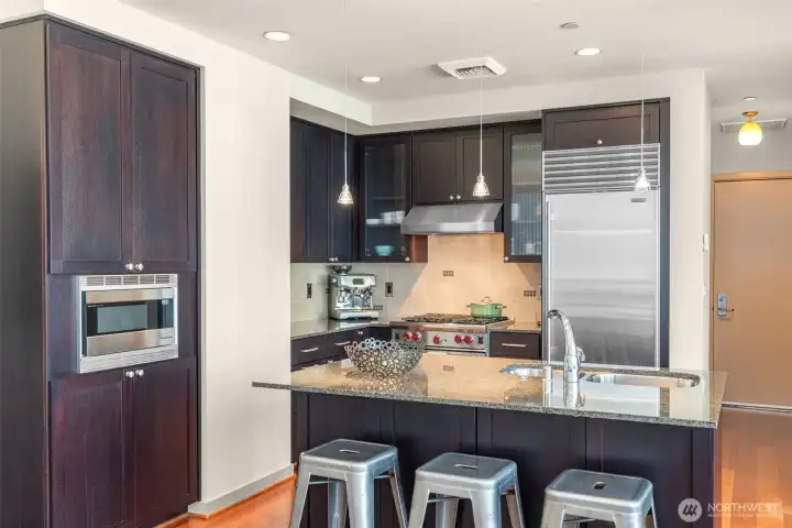 Big kitchen island with eating bar is the center of the culinary action.