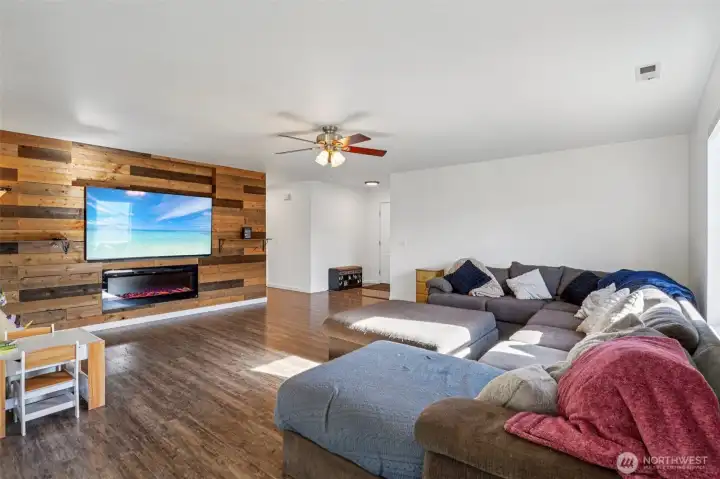 Large living room with a custom accent wall with fireplace - Yes, the new 75" TV and sound bar are included!