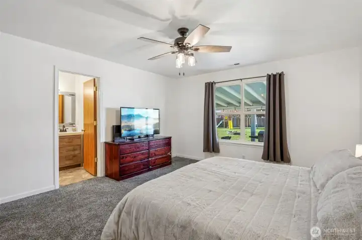Primary has a view of the backyard/patio and includes an en suite bathroom
