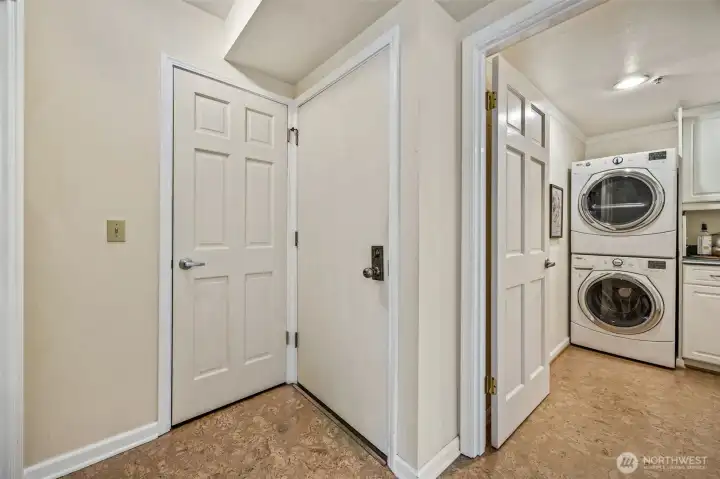 Entryway with coat closet and double door closet with built in sliding shelves