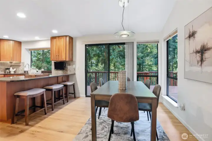 Dining area leads to the expansive deck with additional outdoor dining.