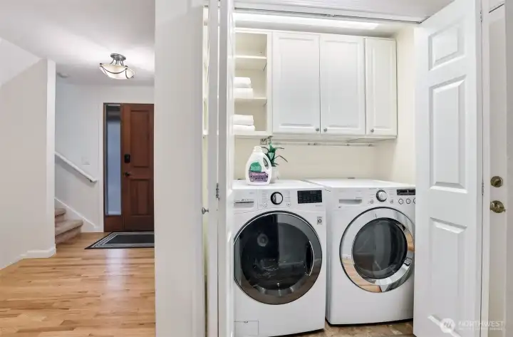 Laundry closet on the main floor in the hallway leading to the garage door.