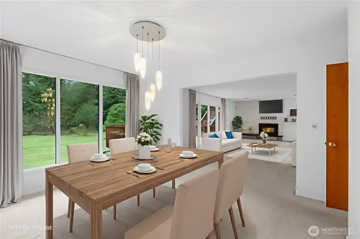 The Dining room is great for entertaining as it is open to the living room with access to the beautiful deck (this picture has been virtually staged)