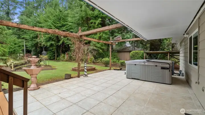 Nice patio partially covered with hot tub to relax in.
