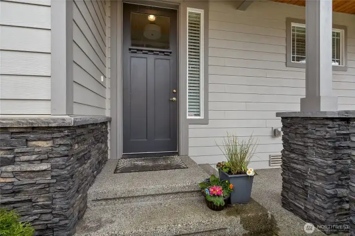 Covered front porch with room for decor and relaxing on a warm day.  Welcome Home!