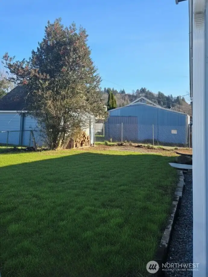 Fully fenced yard, grass is virtually staged