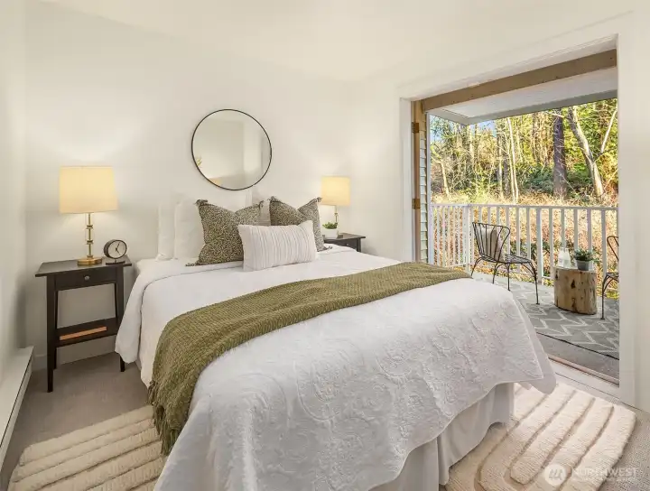 Bedroom, or office, with french doors opening up to private balcony.
