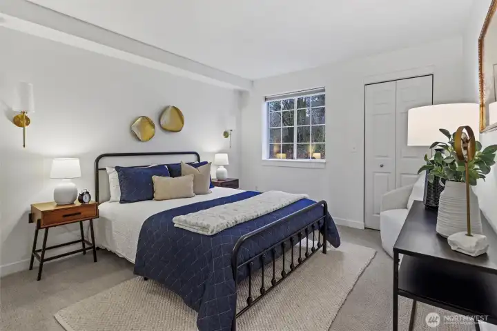 Generously sized primary bedroom with S-facing window. First walk-in closet pictured here.