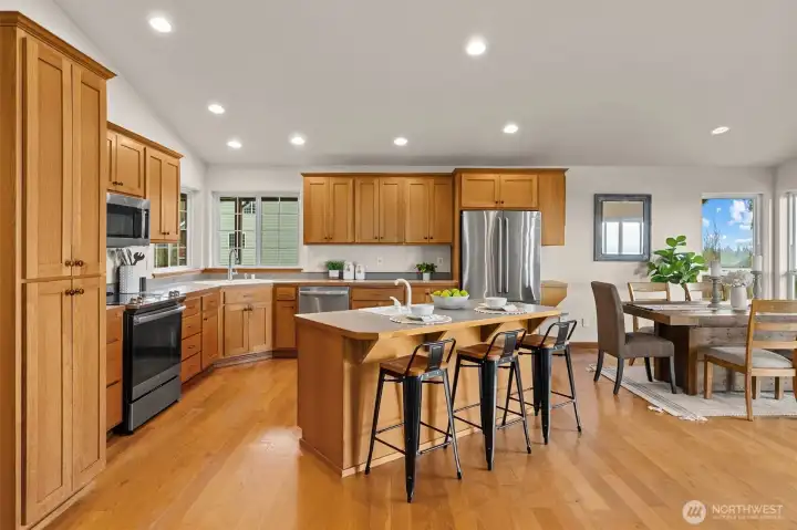 Kitchen has solid wood cabinets and plenty of room for more than one cook.