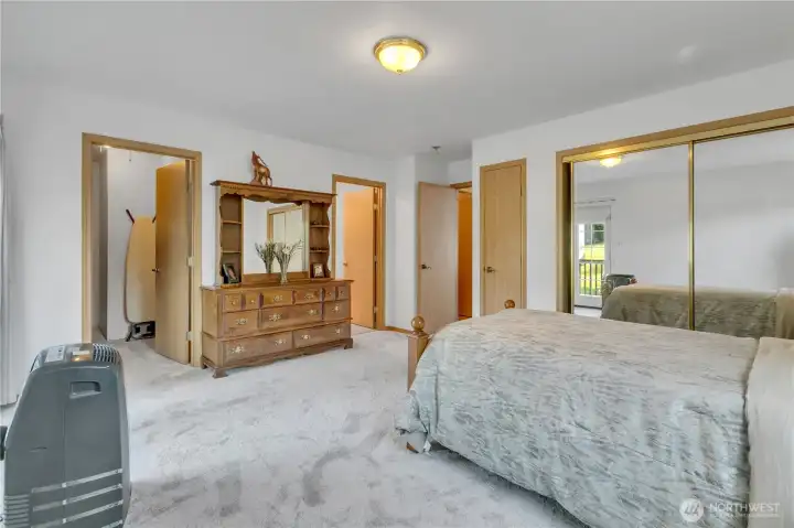 Walk-in closet, extra closet and a primary suite bathroom.