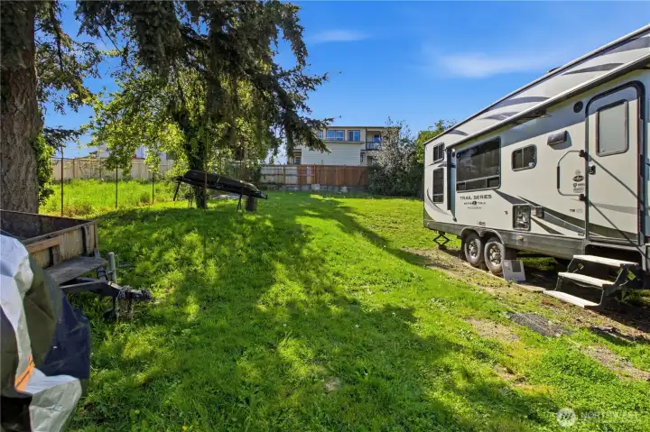 The yard is very spacious, mostly fenced, has RV Parking with a 30 AMP breaker set up, and an RV dump connection already!