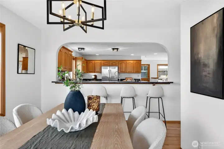 Elegant dining space with designer lighting, modern finishes, and seamless connection to the spacious kitchen and entertaining areas.