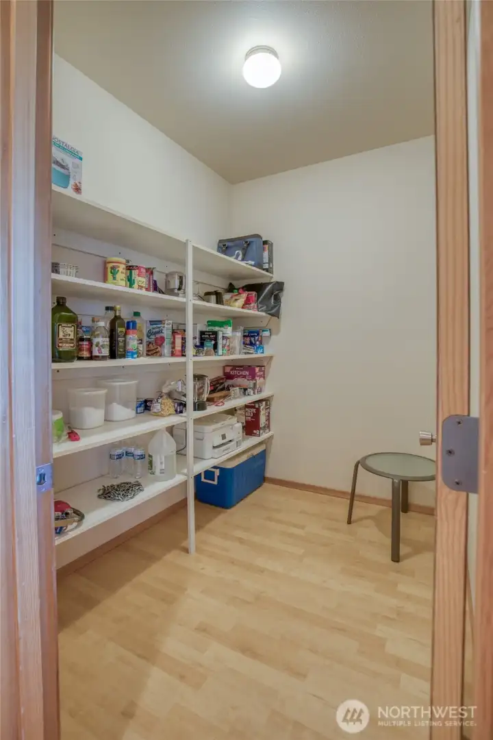 Walk in pantry provides storage in addition to ample cabinet space in the kitchen.