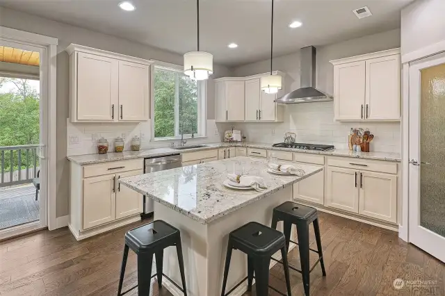 Open kitchen with quartz counters.