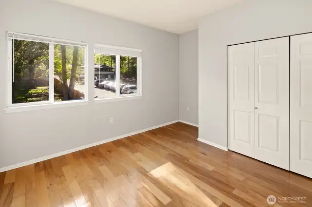 Master bedroom with a view of beautiful greenery.