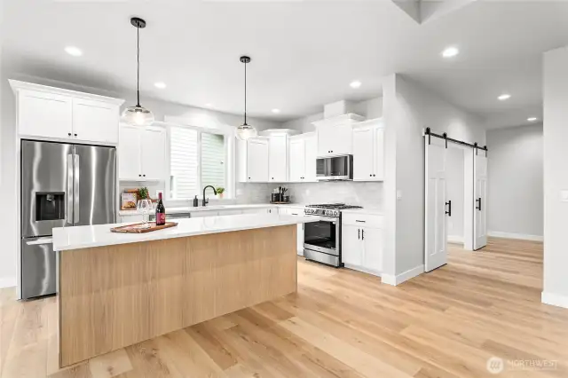 The hallway on the right leads to office, front entrance, two bedrooms and a full bathroom.