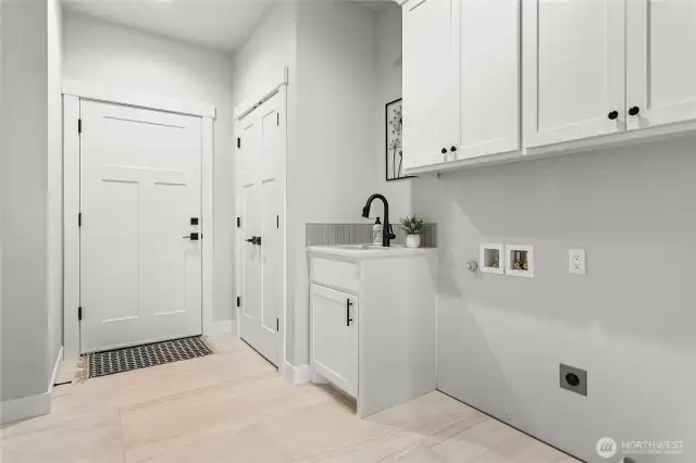 Nice sized utility room with extra storage.