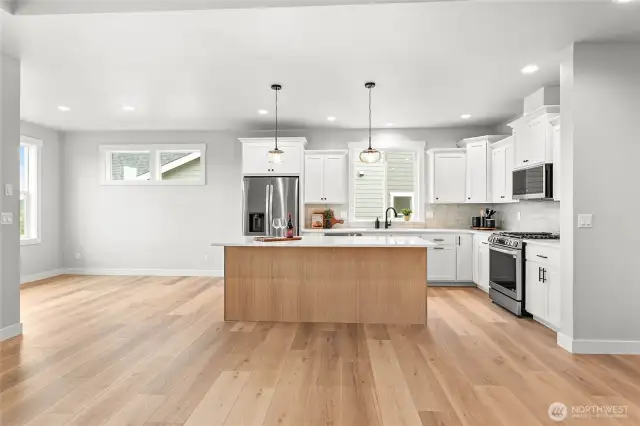 Stainless steel appliances with a gas cook top.