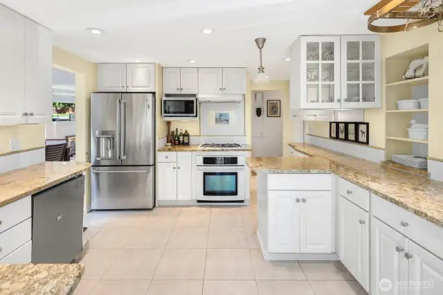 Thw custom built-ins and stone counters accent the chef's kitchen. Space and flow as you create meals and snacks.