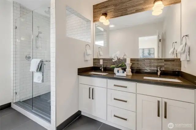 The primary ensuite is bright and light with clean lines and finishes.