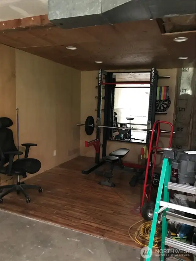 Pardon the construction supplies...  This little finished nook has served as a home gym.