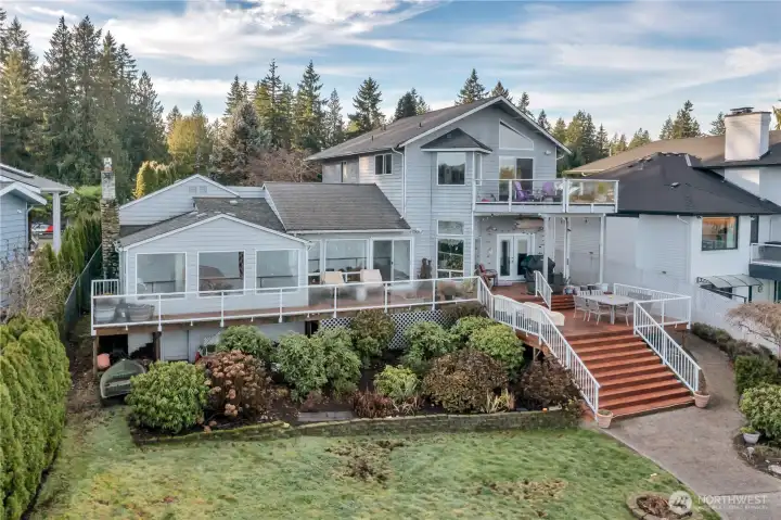 Established landscaping with abundant blooms from spring to fall, enhancing the lakefront setting