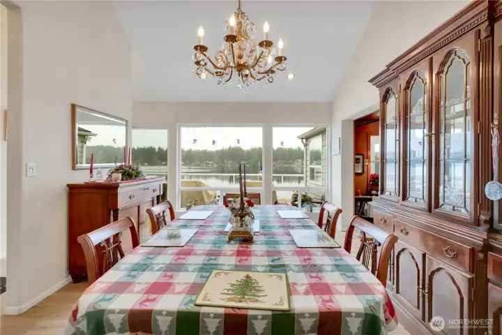 Elegant dining room with ample space for entertaining and view of the water