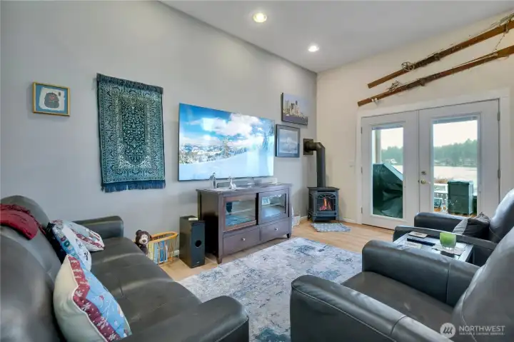 Family room with water view and gas stove with gas window display