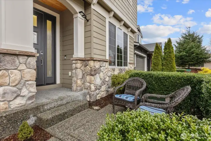 Covered entry with a relaxing front patio - perfect for catching up with friends and neighbors