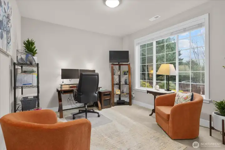 The large den is a great flex space - use as a home office, guest room or more!