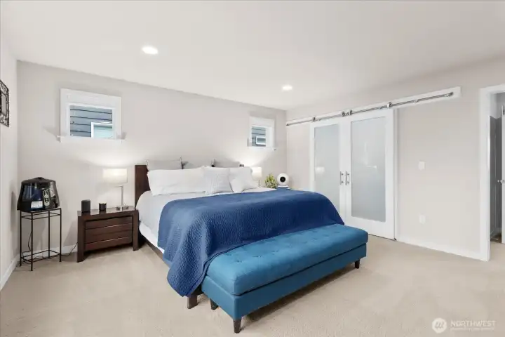 Behind the barn doors is one of two walk-in closets.