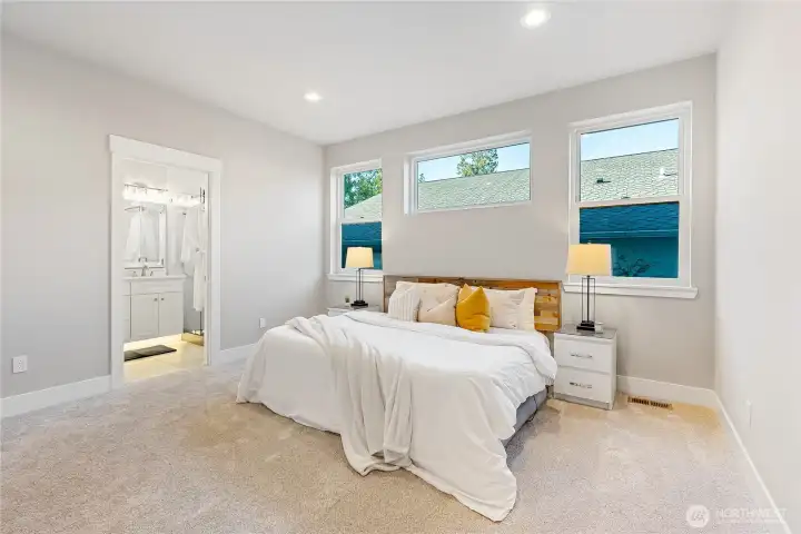 This home has 2 primary suites! One on each level. This is the downstairs Primary Suite - complete with a primary bathroom and walk-in closet. Large room, large windows for natural light!