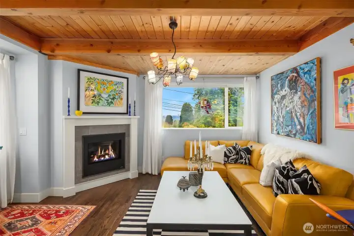 Living room so warm and inviting in this open concept home. With views of the city (Space needle in the distance)