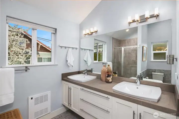Spacious primary bath on the upper level  also includes  soaking tub and washer and dryer.