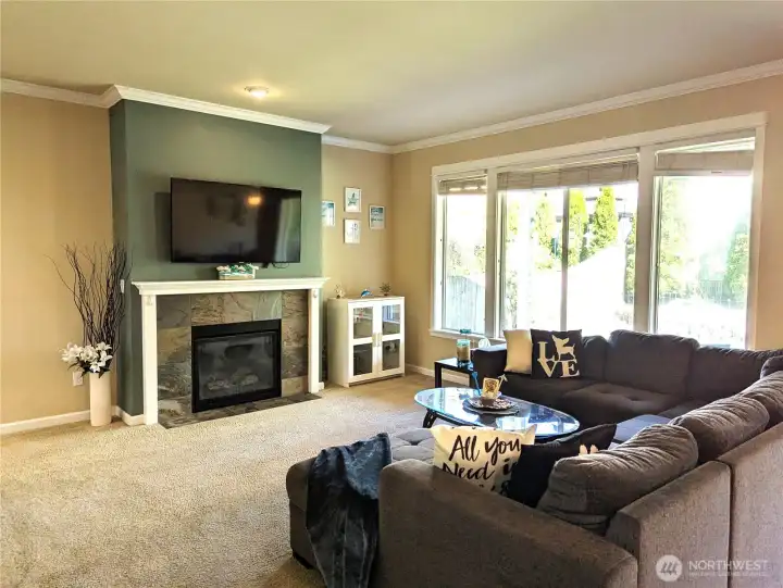 Living room is spacious and has a gas fireplace.
