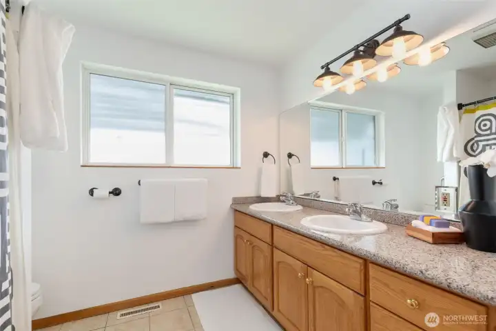 Main floor full bathroom with double sink vanity.