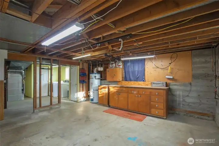 Large unfinished space with workbench.  Plenty of room to add more tools or design a living space.