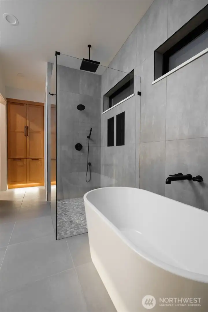 Retreat to a luxurious primary bath after a day on the water.