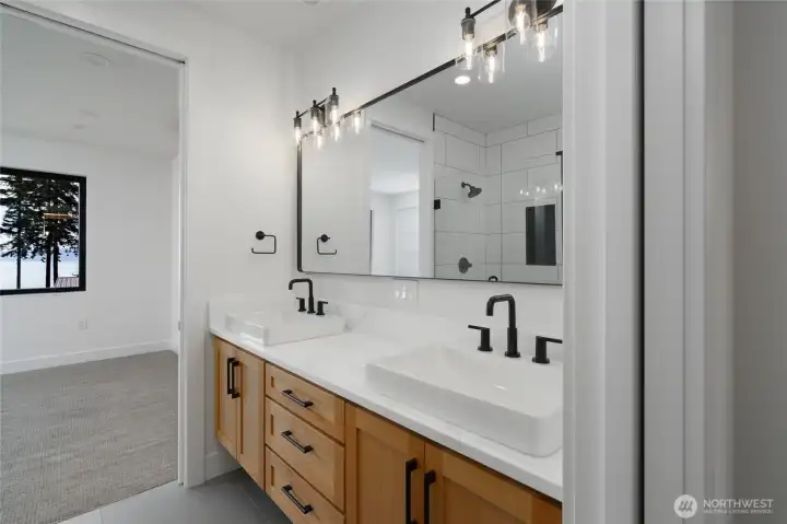 Downstairs bathroom with dual vanity and elegant finishes.
