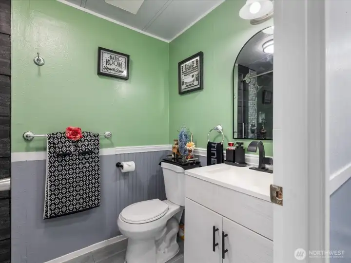 2nd bathroom with custom tiled shower, glass doors and updated vanity and fauset.