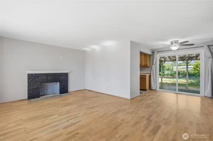 Open living and dining spaces create an easy flow for entertaining, with hardwood floors throughout and sliding glass doors leading to the covered patio and fully fenced backyard.